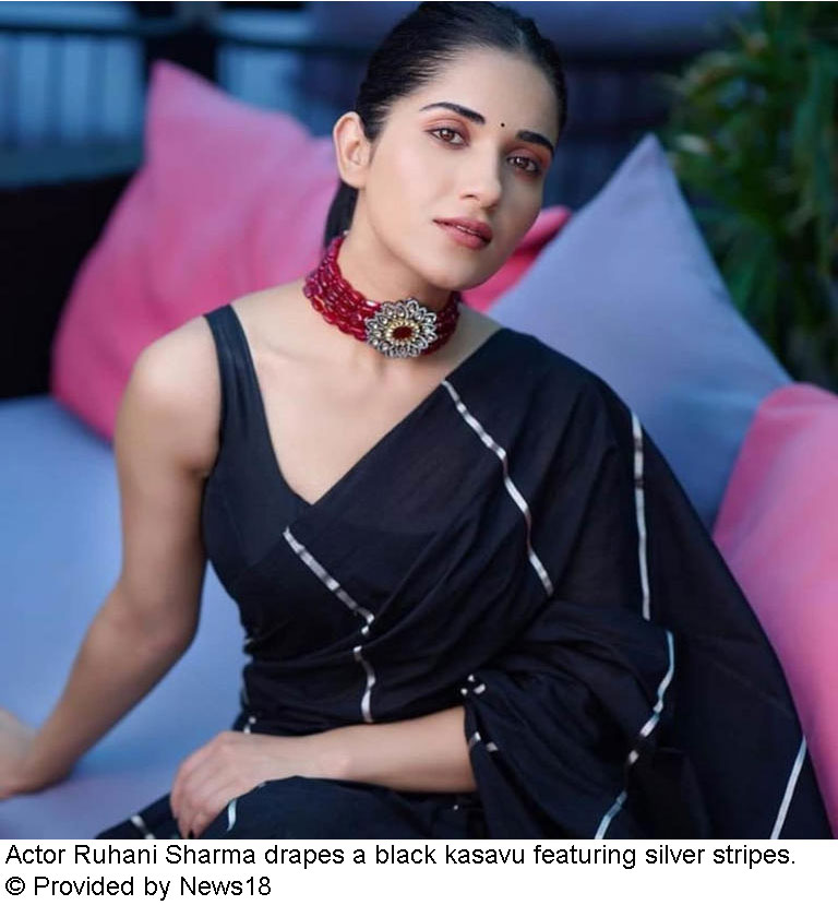 Actor Ruhani Sharma drapes a black kasavu featuring silver stripes.